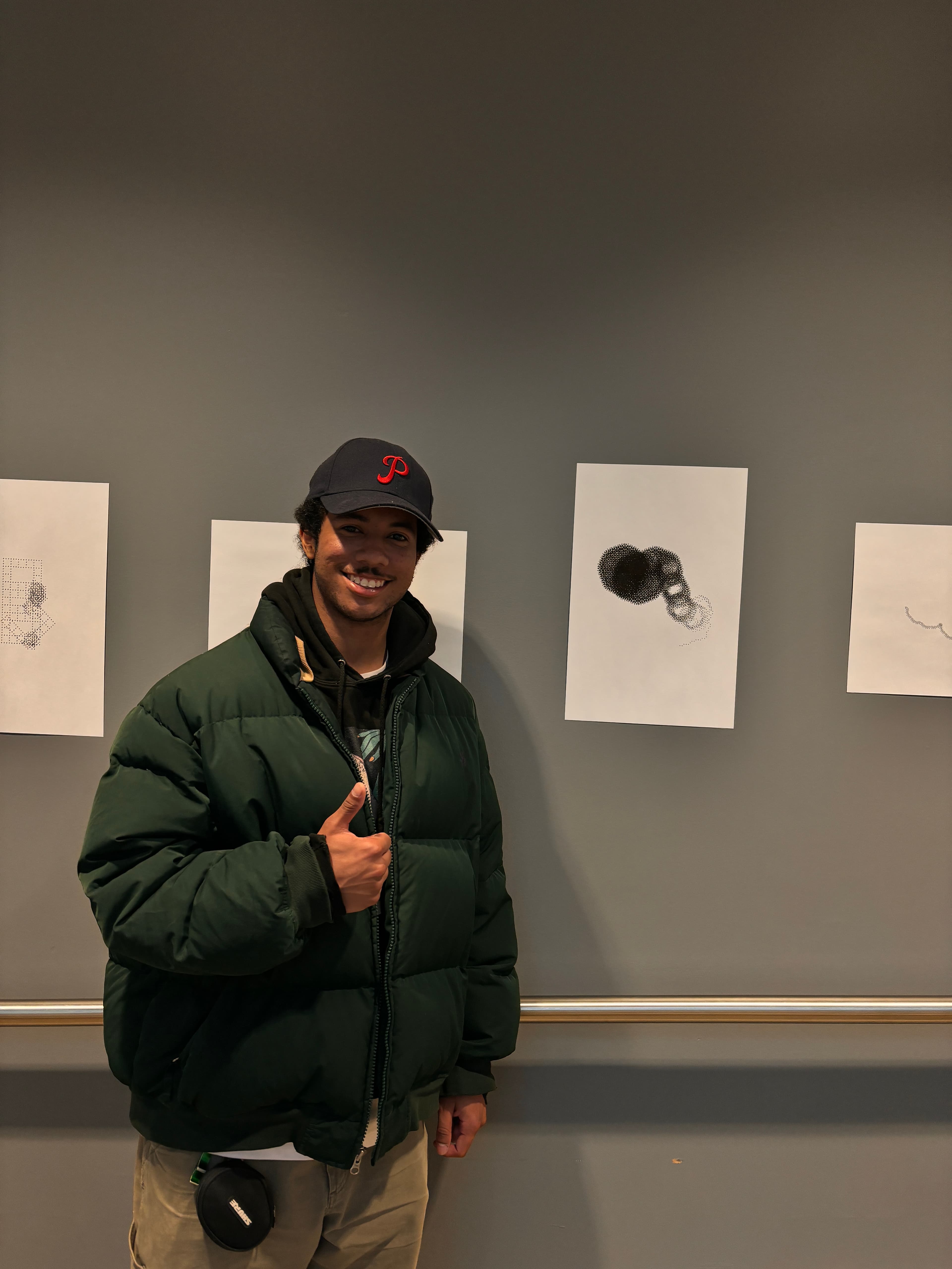 A man standing next to a generative art flower gives a thumbs up at the camera.